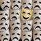 Smiling theater mask in a crowd of sad masks