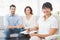 Smiling therapist with patients looking at camera