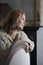 Smiling Thoughtful Woman Leaning On Chair