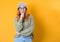 Smiling thoughts young woman thinking. Close up portrait of inspired girl with smile face expression, isolated on yellow