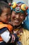A smiling tibetan lady with her son