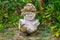 Smiling tiki. Carved stone Polynesian sacred idol statue. Raivavae island, Astral islands, French Polynesia, Oceania.