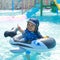 Smiling toddler boy swimming in inflatable ring in pool
