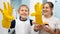 SMiling toddler boy wearing yellow rubber gloves laughing while doing housework and home cleanup