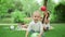 Smiling toddler standing in park. Children playing together outdoors