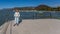 Smiling tourist with casual clothes posing on the seafront with Lake Chapala in the background