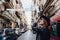 Smiling traveler girl exploring streets of Naples