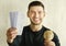 Smiling Traveler Showing Flight Tickets Holding World Globe Sitting Indoor