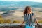 Smiling traveller woman in Tuscany looking into distance