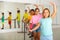 Smiling tween girl practicing classic dance moves near ballet barre