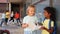 Smiling tween girls friendly discussing outdoors in schoolyard during break in lessons