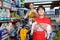 Smiling tweenager boy embracing his puppy during family shopping in pet accessories shop