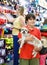 Smiling tweenager boy embracing his puppy during family shopping in pet accessories shop