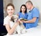 Smiling tweenager girl with her puppy visiting veterinarian clinic