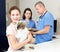 Smiling tweenager girl with her puppy visiting veterinarian clinic