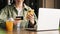 Smiling Unrecognizable Woman Holding Credit Card and Smartphone Making Online Shopping While Sitting at a Cafe Table