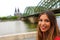 Smiling urban girl with Cologne Cathedral and Bridge on the background, Germany, Europe
