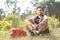 Smiling valentine male with bunch of roses sitting on grass