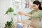 Smiling vegan woman making a smoothie in kitchen