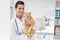 Smiling veterinarian with a cute cat in her arms