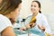 Smiling visitor listening beautician in medicine center