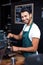 Smiling waiter making cup of coffee