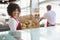 Smiling waitress carrying basket of bread