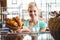 Smiling waitress carrying basket of bread