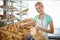 Smiling waitress carrying basket of bread