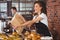 Smiling waitress giving paper bag to customer