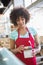 Smiling waitress holding cupcake and box