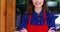 Smiling waitress standing at the entrance of cafÃ©