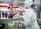 Smiling waitress taking cooked meals in restaurant kitchen