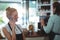 Smiling waitress talking on mobile phone