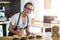 Smiling waitress working at counter in cafÃ©