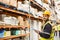 Smiling warehouse manager holding clipboard