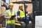 Smiling warehouse worker and forklift driver