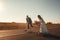 Smiling wedding couple riding a on scooters along the road outside the city at sunset. Place for text or advertising