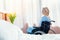 Smiling wheelchair woman looking at tulips in hospital