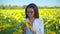 Smiling woman agronomist posing in sunflower field