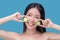 Smiling woman applying organic cucumber face mask