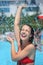 Smiling woman bathes in pool under water