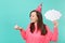 Smiling woman in birthday hat looking on cake with candle, hold empty blank Say cloud, speech bubble for promotional