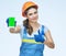 Smiling woman builder holding smartphone showing thumb up.