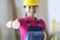Smiling woman builders in protective helmet extending their hand closeup