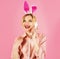 Smiling woman in bunny ears talking on phone. Easter greetings. Communication. Rabbit girl.