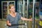 Smiling woman with cart opening fridge