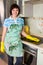 Smiling woman cleaning cooker