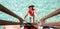 Smiling woman climbs a ladder out of clear turquoise water on the tropical island Bora Bora in French Polynesia