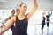 Smiling woman dancing ballet and looking away in class